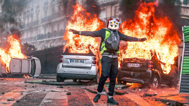 A protester in central Pavia City throwing an object.